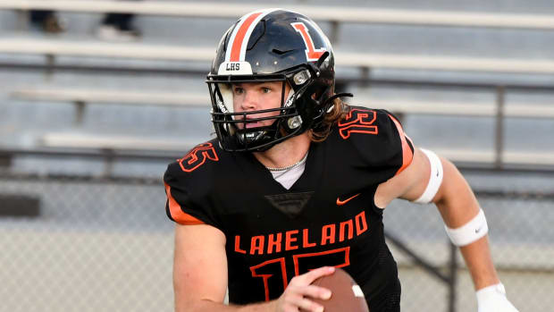 Lakeland quarterback Zander Smith rolls out of the pocket and looks for a receiver downfield against Philadelphia St. Joseph’s Prep on Friday at Bryant Stadium in Lakeland. 